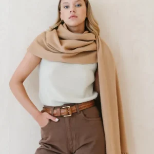 Luxurious TBCo lambswool blanket scarf in camel with fringe detail, styled casually with white top and brown trousers