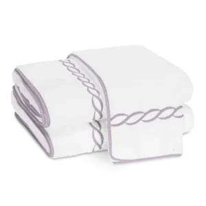 Matouk Classic Chain bath sheets, white with lavender chain embroidery, folded stack.