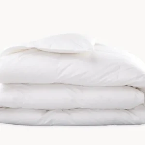 Matouk Montreux duck down comforter folded in white, showing plush quilted chambers.