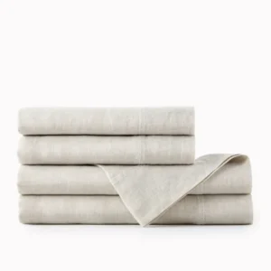Peacock Alley European Washed Linen sheet set folded in natural oatmeal tones.