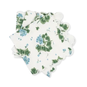 Matouk Geranium Linen dinner napkins with blue floral print and scalloped edges.