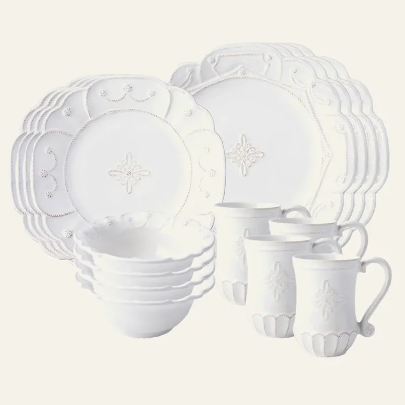 Juliska Jardins du Monde white embossed ceramic dinnerware set with plates, bowls, and mugs.