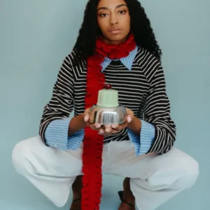 Model wearing TBCo Merino Wool Skinny Scarf in Red Ruffle with ruffled trim styled over striped top and white trousers