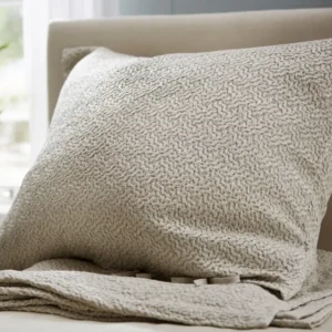 SDH Allegro Platinum jacquard pillow sham and throw on neutral upholstered bed.