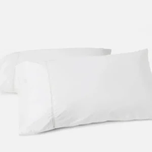 Coyuchi Lattice Percale pillowcase pair in white, two pillowcases stacked on neutral background.
