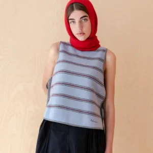 Model wearing TBCo Merino Wool Tie Vest in Blue Stripe with side ties and embroidered logo over black skirt