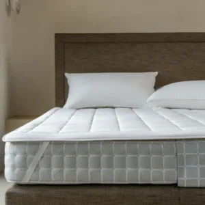 Luxury wool mattress protector secured to a Savoir mattress with elastic strap