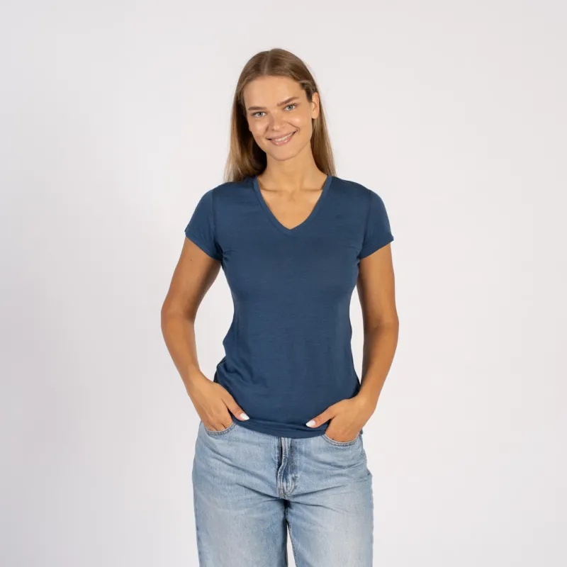 Woman smiling in a denim blue Merino wool V-neck short sleeve T-shirt.