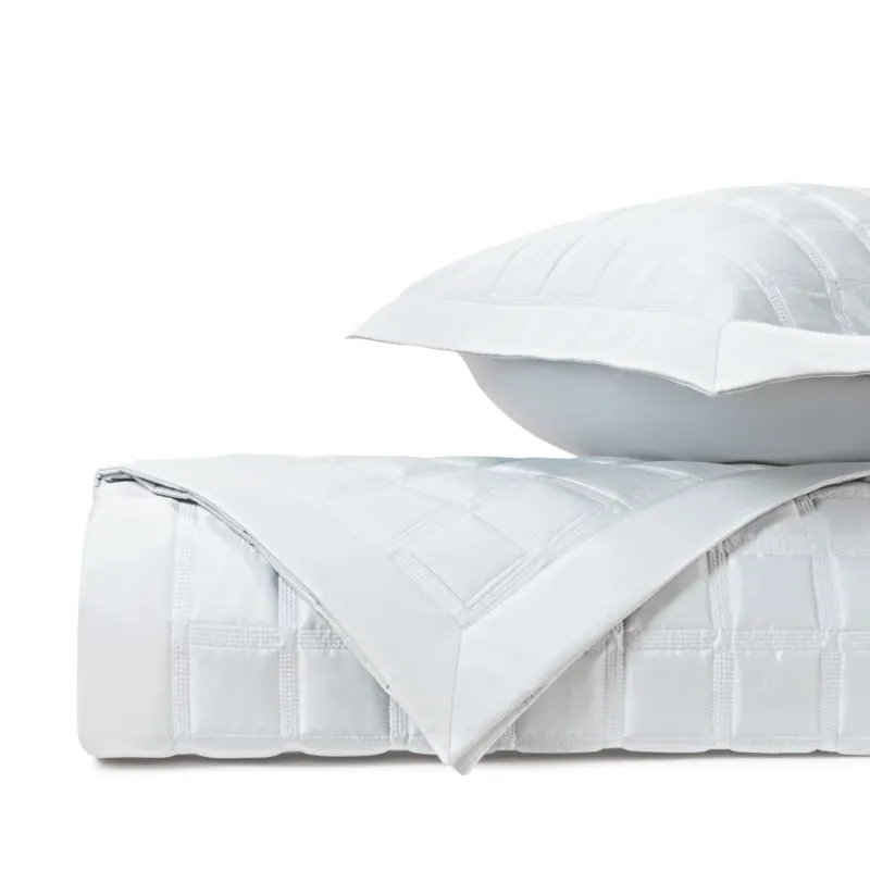 Home Treasures Athens quilted coverlet in white with grid stitching, folded with matching sham.