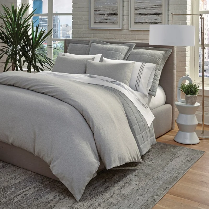Home Treasures Jackson quilted coverlet and euro sham set in silver grey on styled bed.