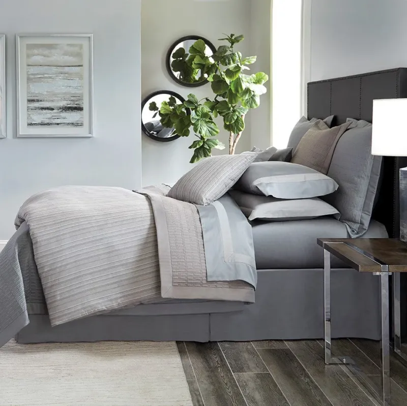 Home Treasures Leonardo quilted coverlet set in silver and platinum on styled bed.