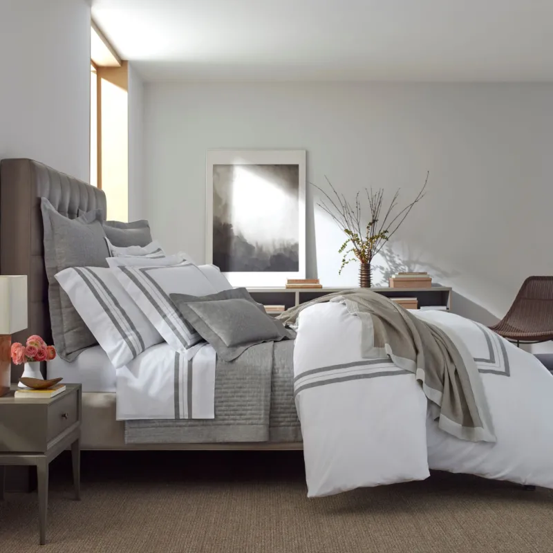 Home Treasures Malibu quilted coverlet and euro shams in silver-grey on styled bed.