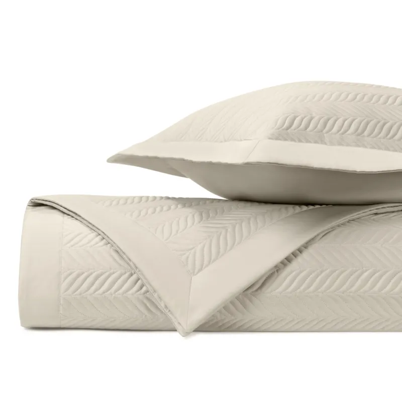 Home Treasures Zurich ivory quilted coverlet and euro sham with leaf motif stitching.